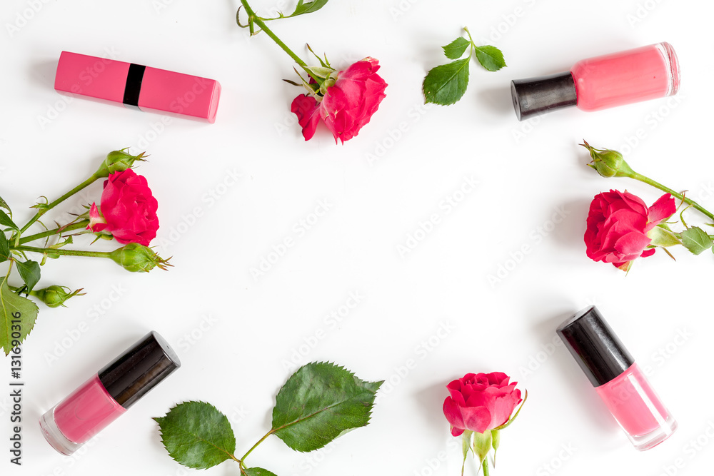 berry color decorative cosmetics with roses white background top view