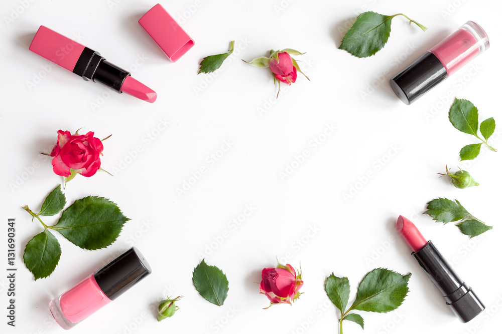 berry color decorative cosmetics with roses white background top view