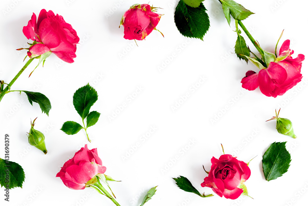 berry color decorative cosmetics with roses white background top view