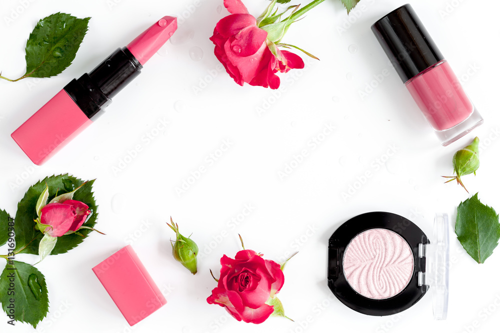 berry color decorative cosmetics with roses white background top view