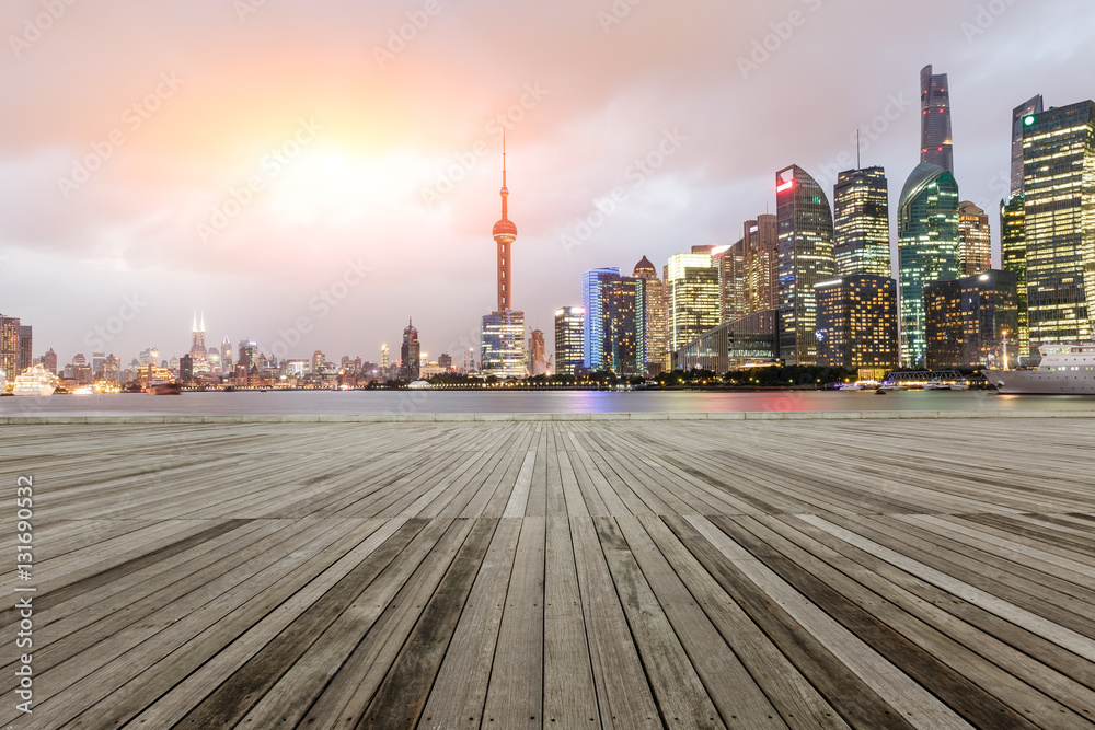 Empty floor with modern skyline and buildings at sunset in Shanghai