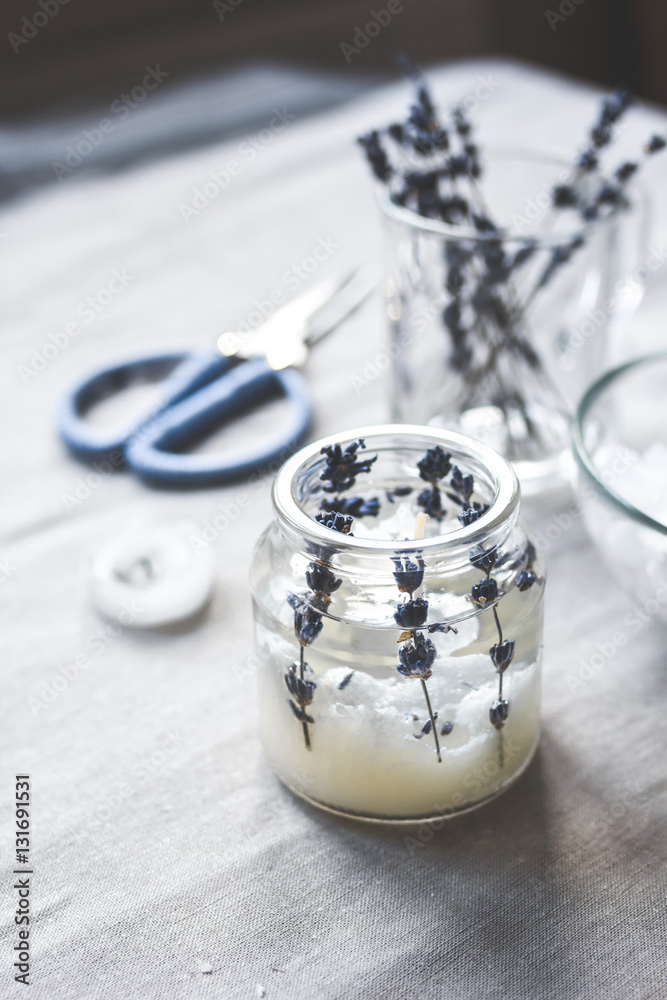 handmade candles with lavender on textile background