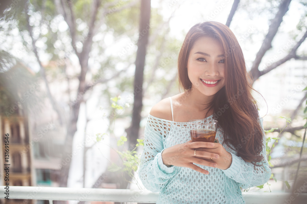 Portrait of a young asian woman drinking her morning tea. Fell r