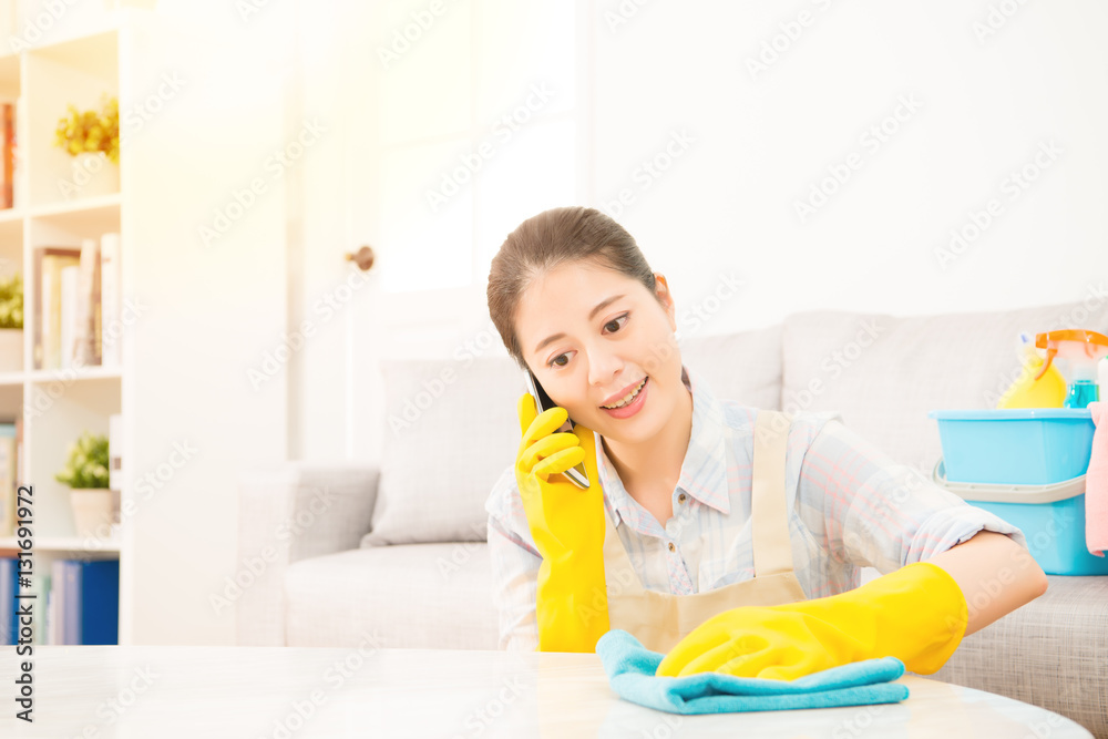 girl cleaning and speaking on phone