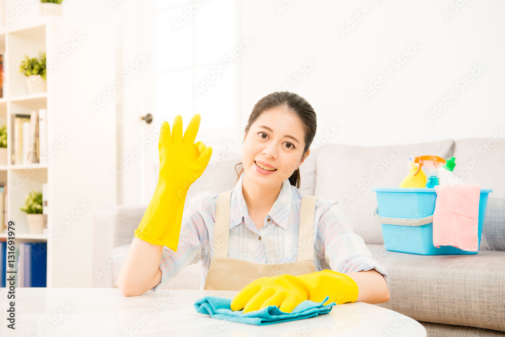 young housewife showing okay gesture done