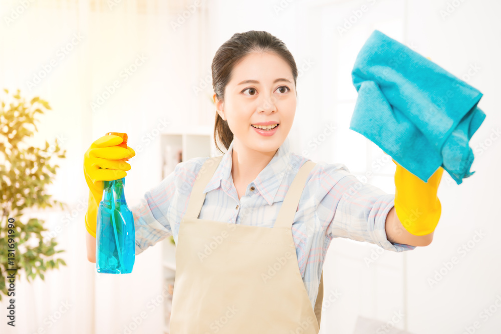 mother cleaning living room window