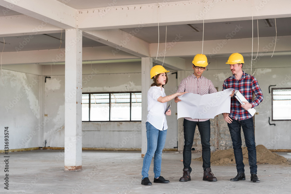 three construction engineers working together in side building