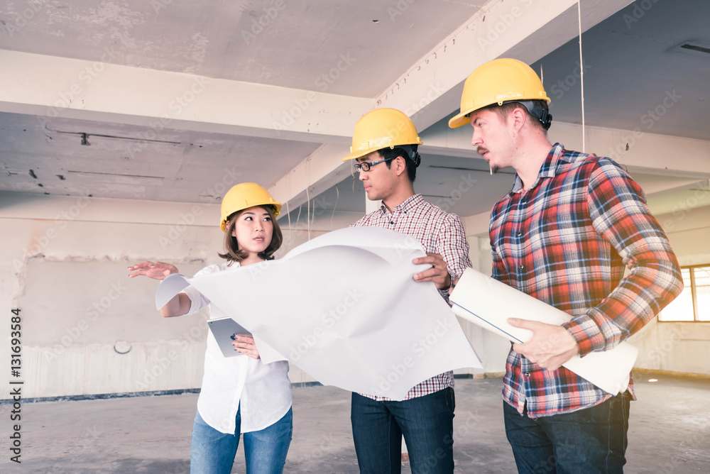 three construction engineers working together in side building