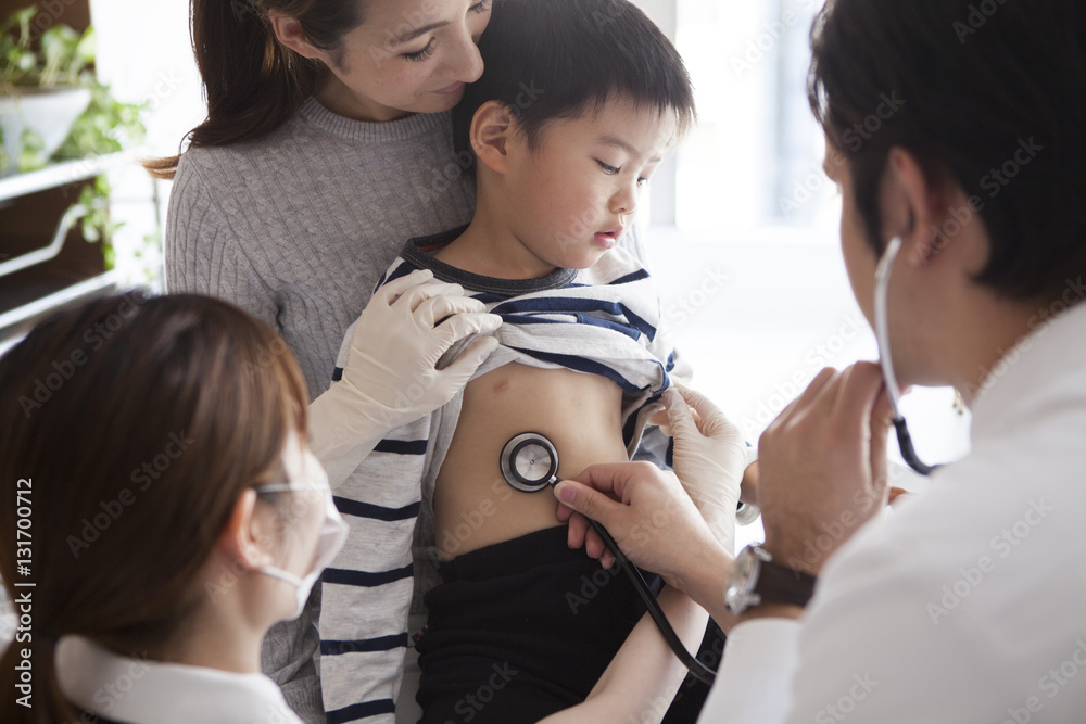 The boy is undergoing a screening in the pediatric department