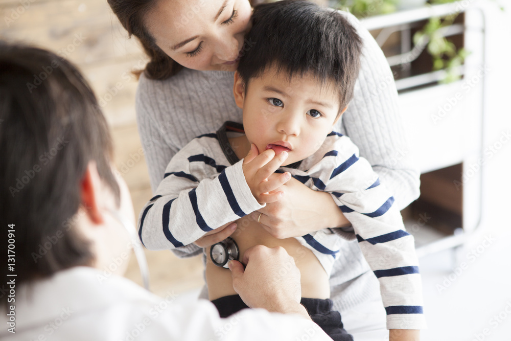 Doctor is applying a stethoscope to children