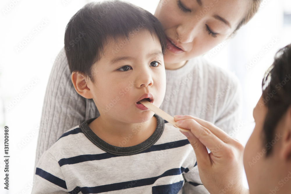 Child is under throat examination