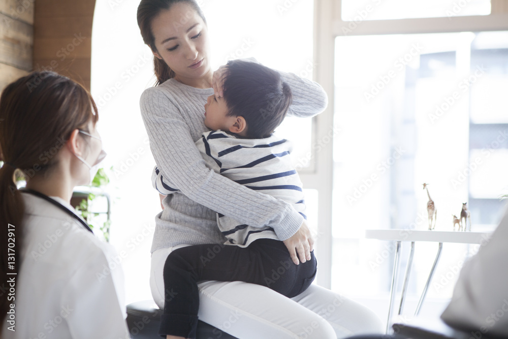 The woman is visiting the hospital with her young son