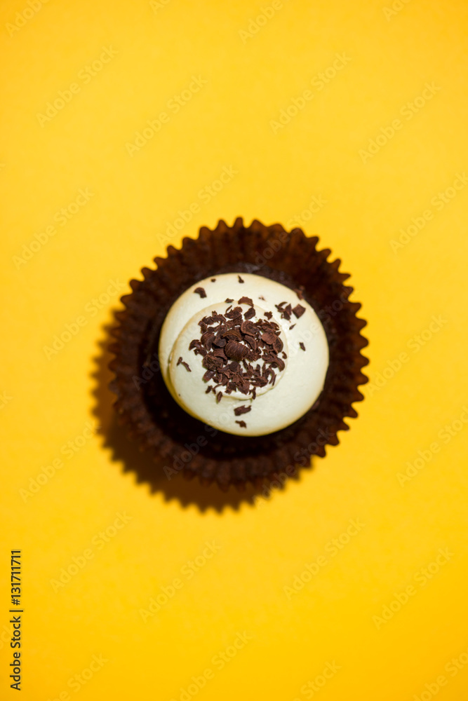 Birthday cupcake against a yellow background