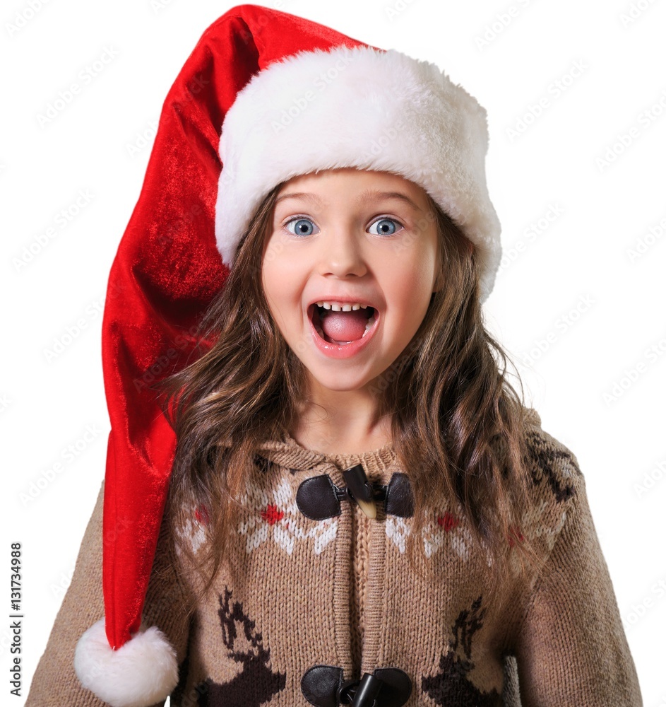 Happy child girl in a christmas hat.