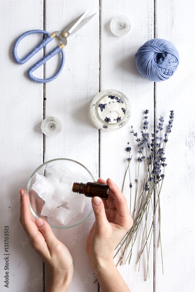 handmade candles with lavender on wooden background top view