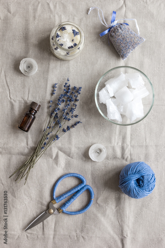 handmade candles with lavender on textile background top view