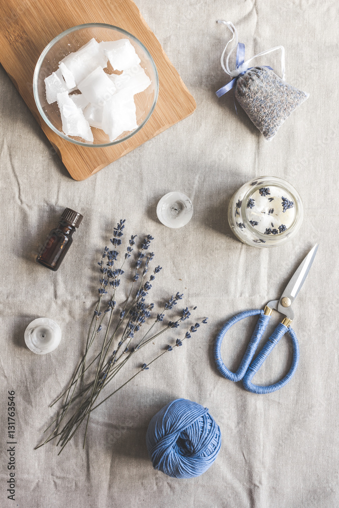 handmade candles with lavender on textile background top view