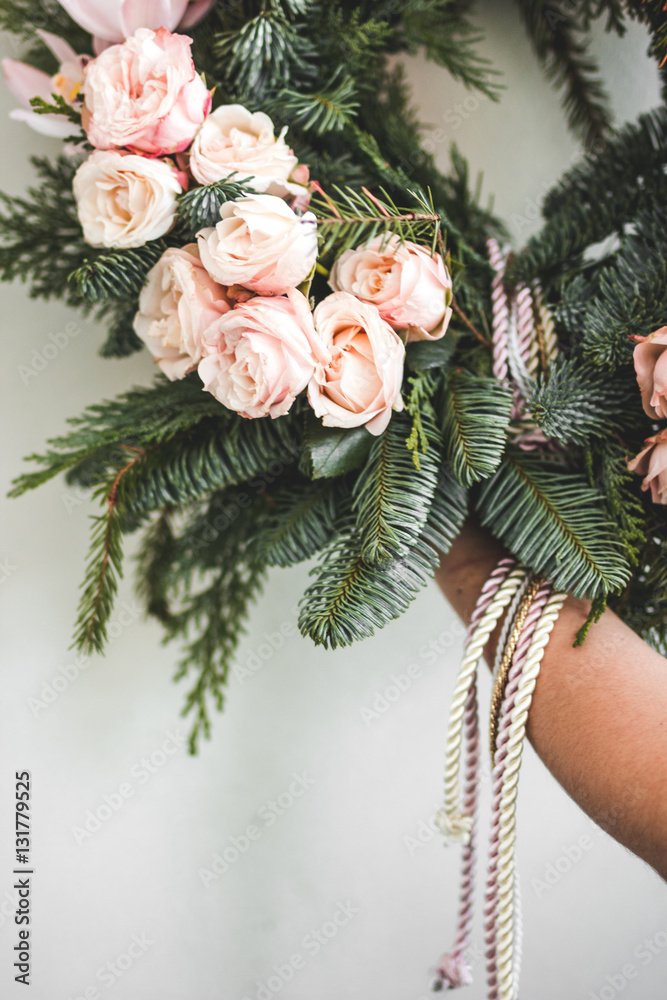 Florist makes Christmas wreath in workshop