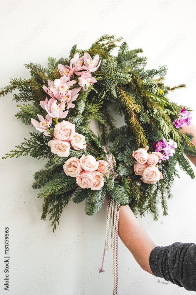 Florist makes Christmas wreath in workshop