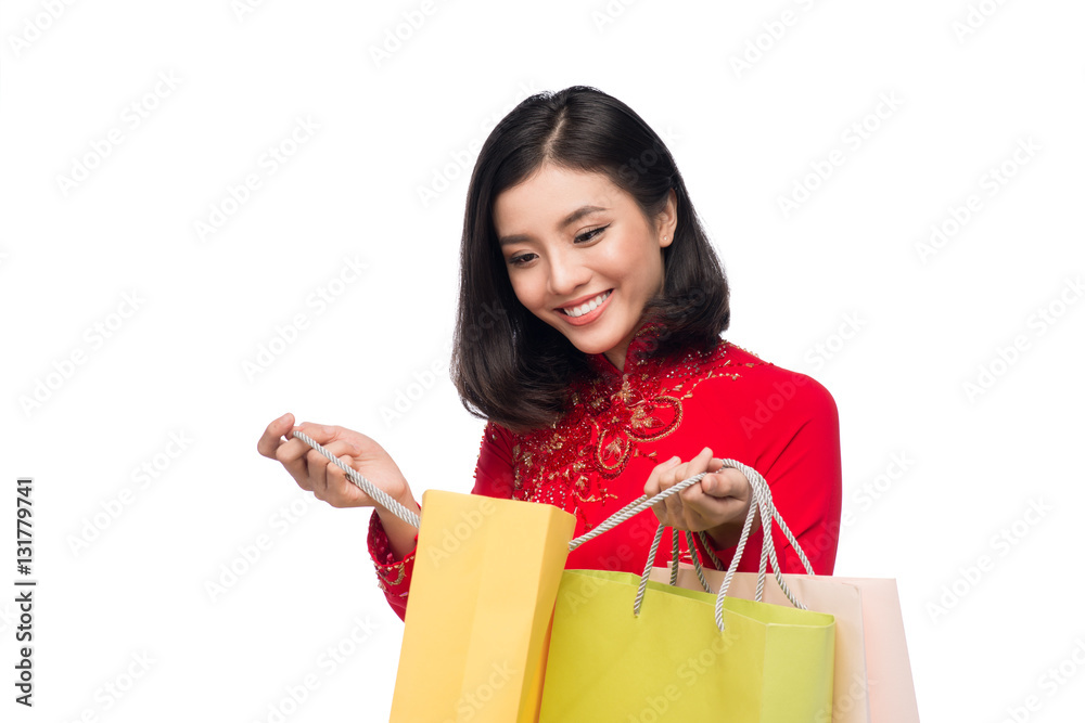 Vietnamese beautiful woman holding shopping bags isolated on white