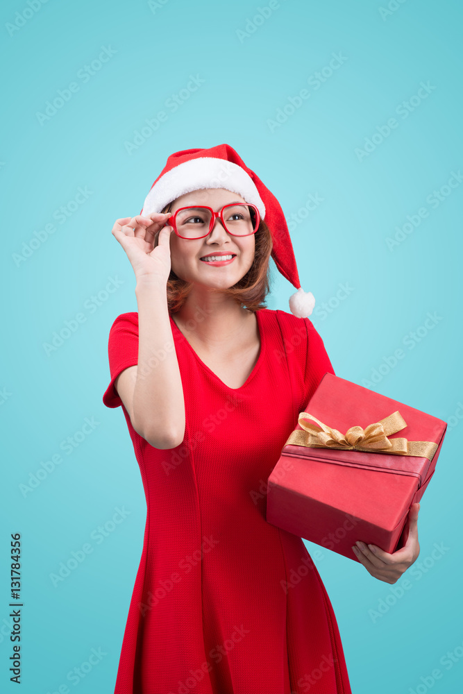 Mrs. Santa. Beautiful young asian woman in santas hat holding a