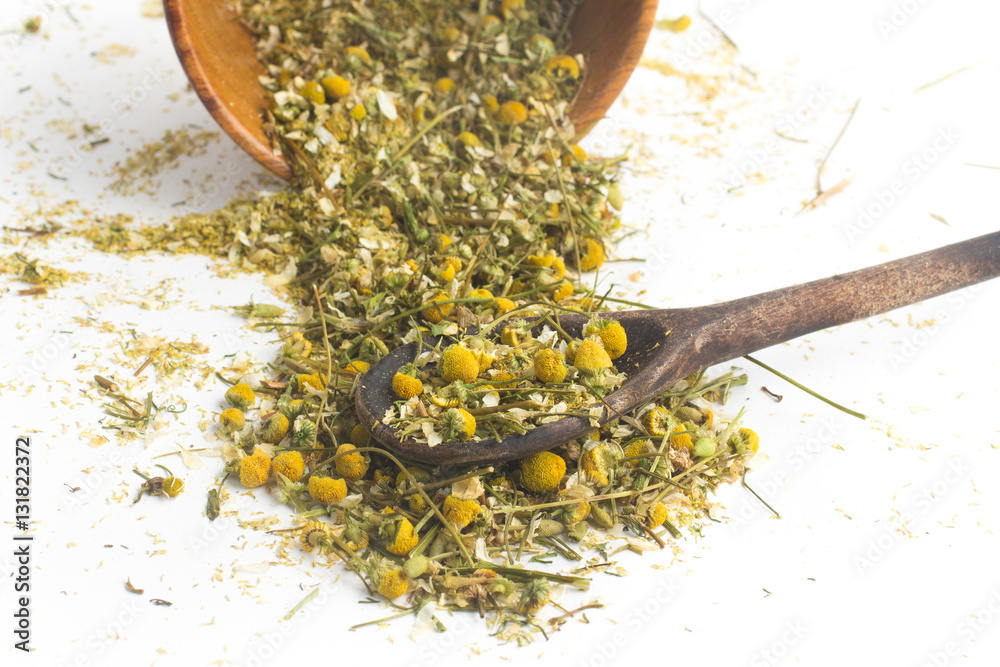 Dry Camomile Tea into a spoon