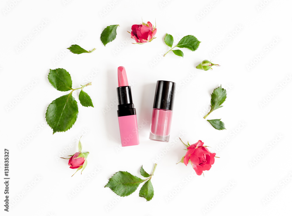 berry color decorative cosmetics with roses white background top view