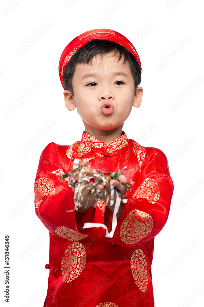 Happy Vietnamese boy in red Ao Dai celebrating New Year with con