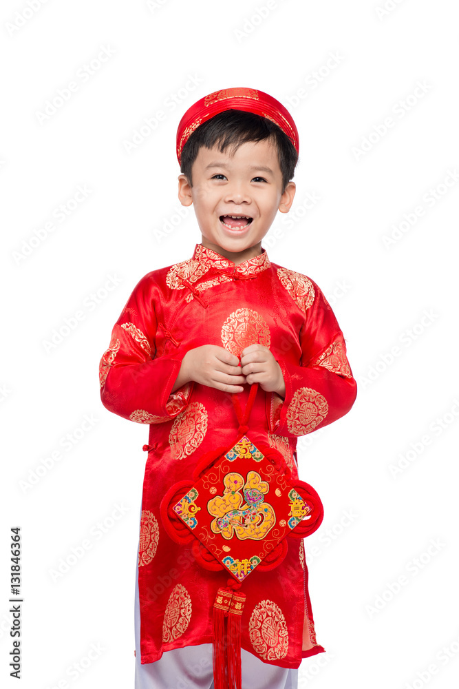 Vietnamese boy cuddling stuffed carp. Portrait of a handsome Asi