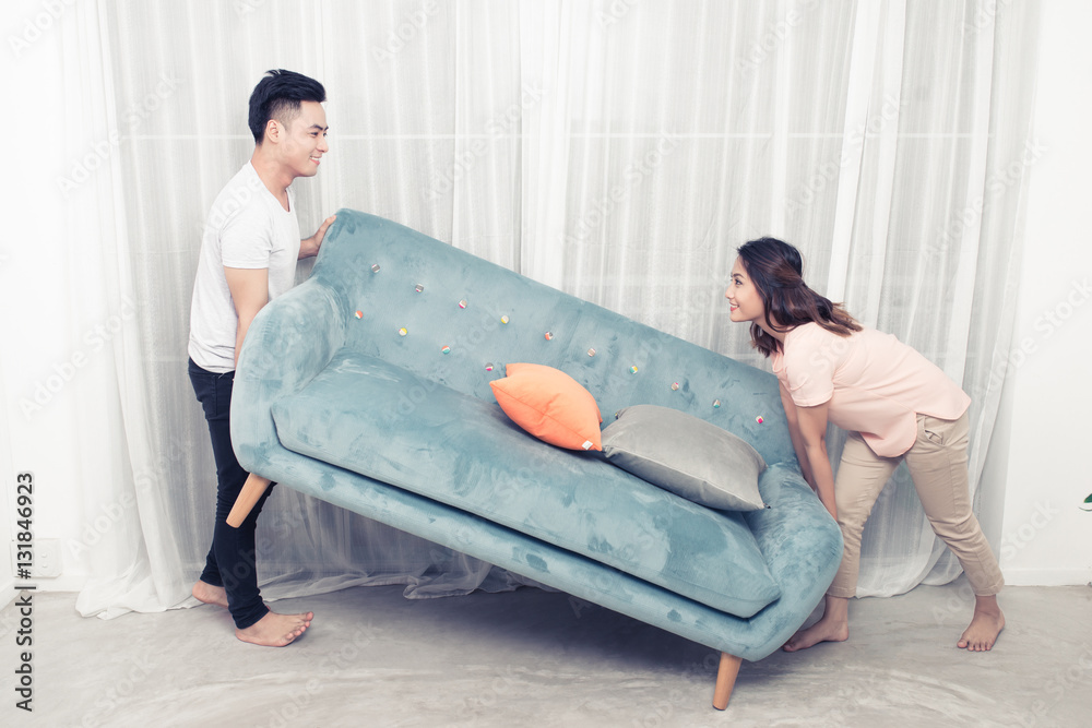 Couple at home relaxing on sofa with digital tablet