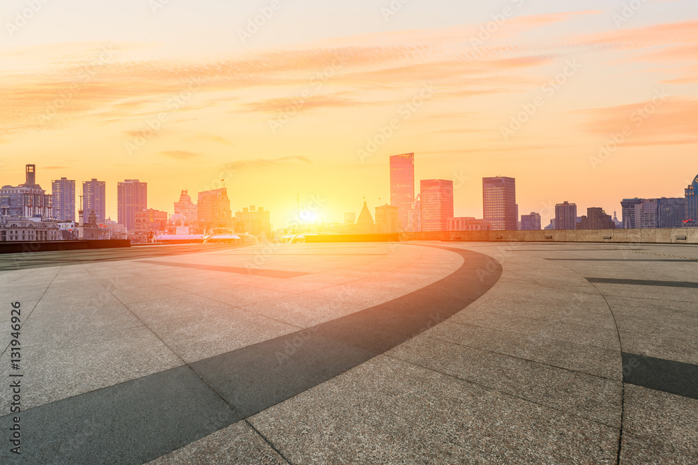 Empty floor with modern skyline and buildings at sunset in Shanghai