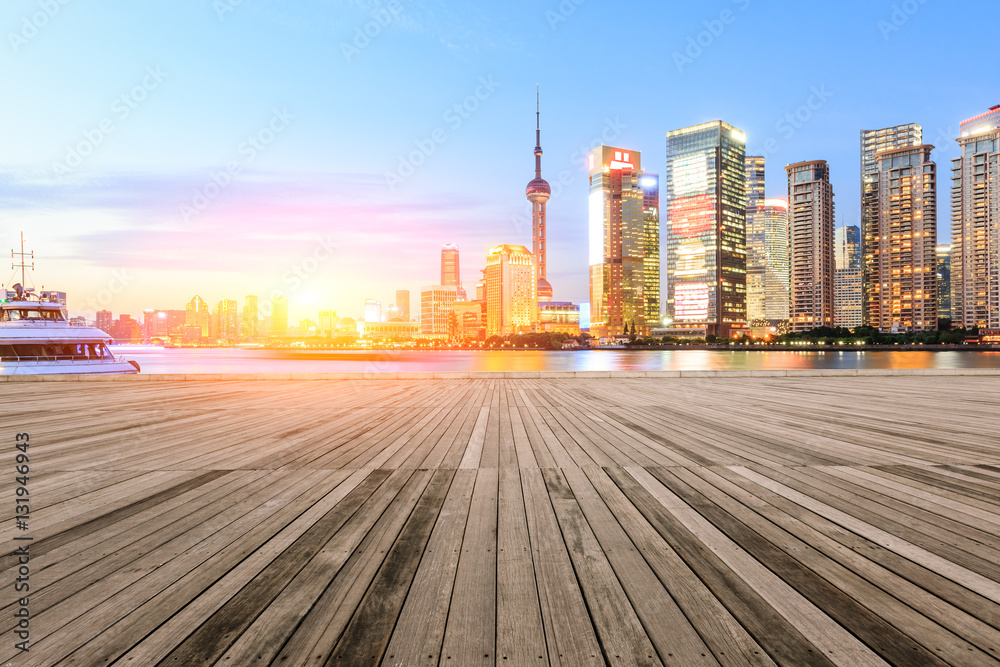 Empty floor with modern skyline and buildings at sunset in Shanghai