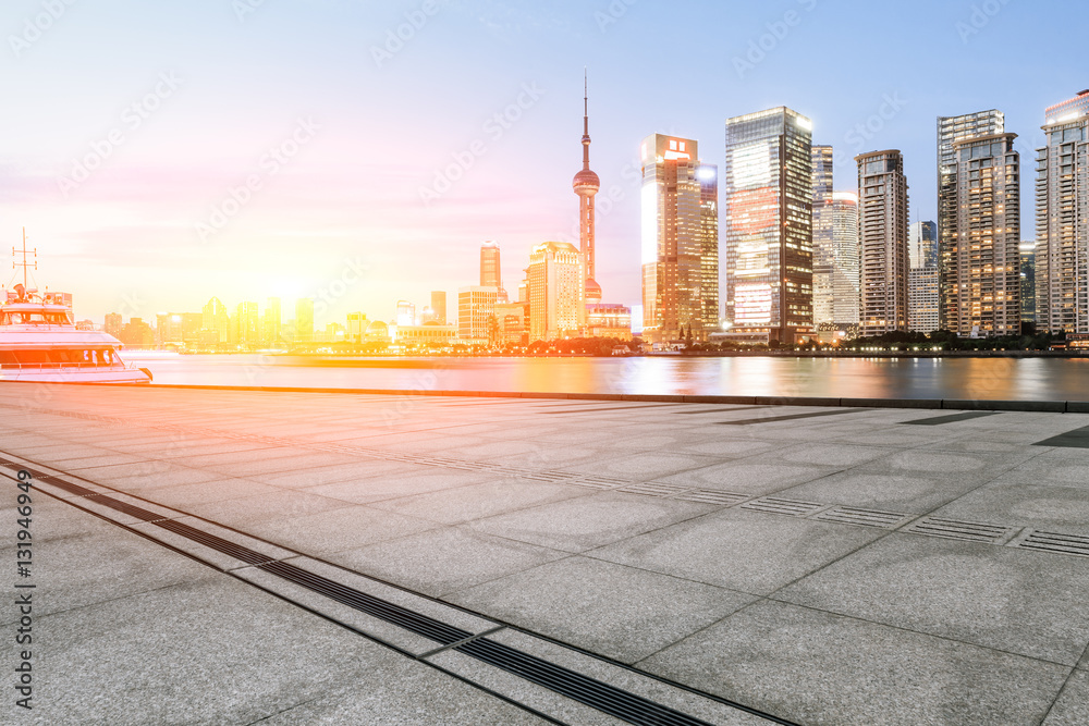 Empty floor with modern skyline and buildings at sunset in Shanghai