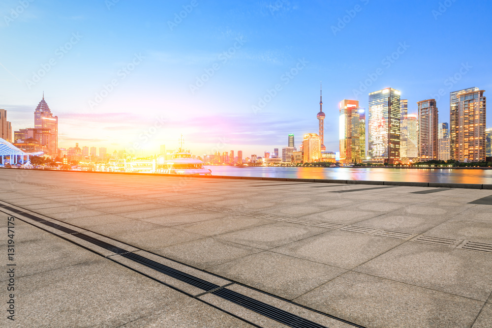 Empty floor with modern skyline and buildings at sunset in Shanghai