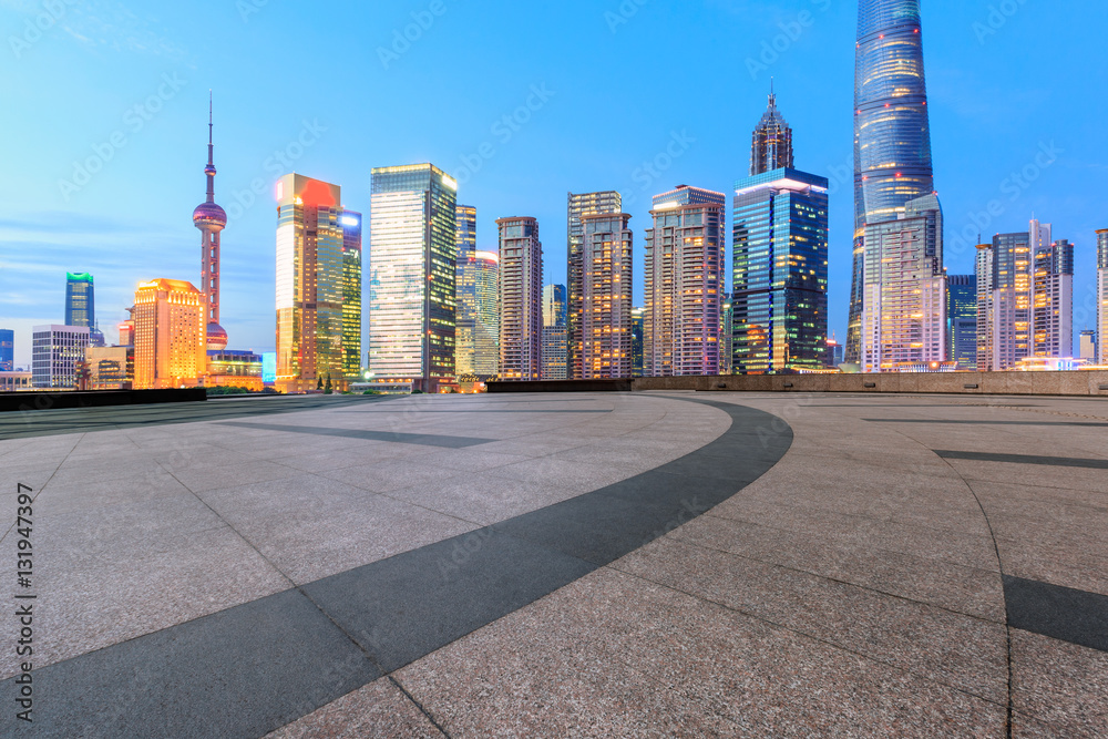 Empty floor with modern skyline and buildings at night in Shanghai