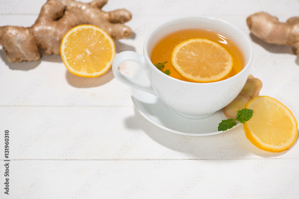 Cup of Ginger Tea with Lemon and Honey on a White Wooden Backgro