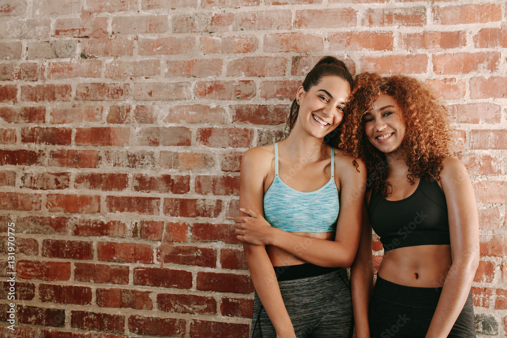 Two happy young women in sportswear