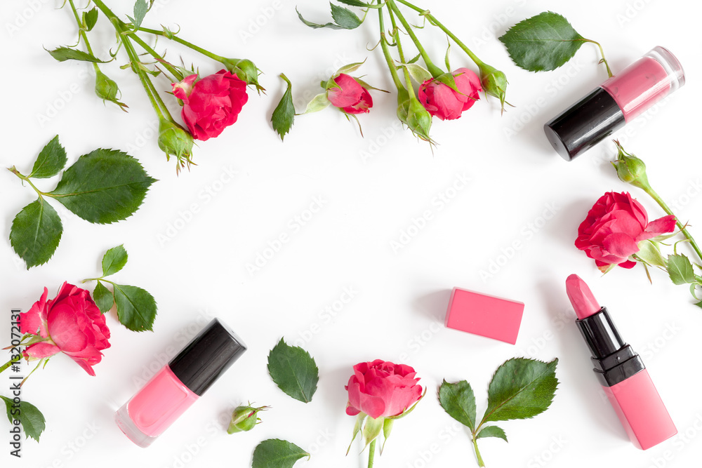 berry color decorative cosmetics with roses white background top view