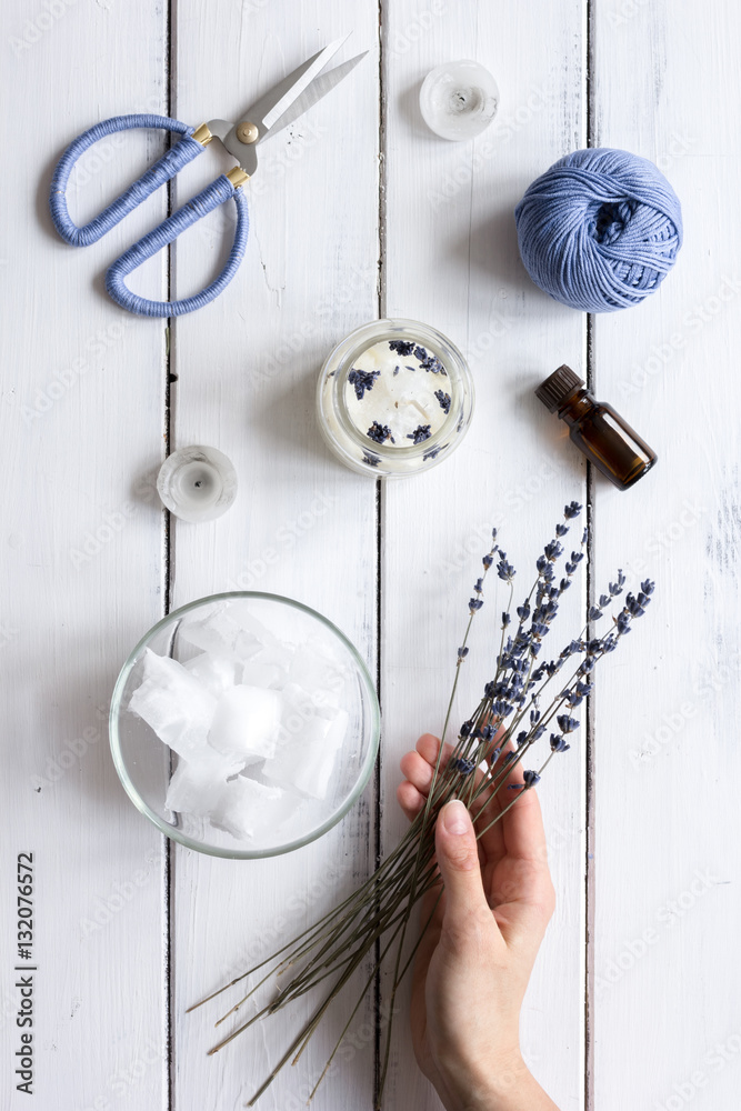 handmade candles with lavender on wooden background top view