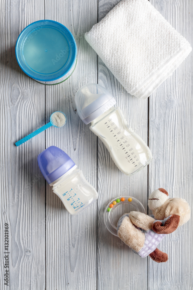 preparation of mixture baby feeding on wooden background top view