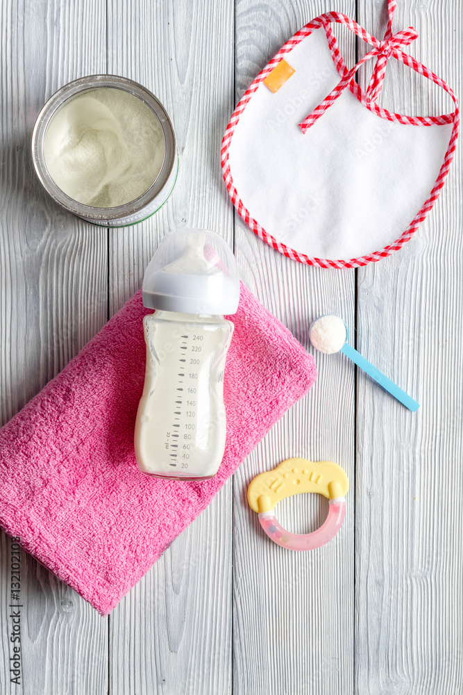 preparation of mixture baby feeding on wooden background top view