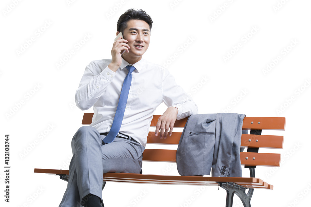 Confident young businessman talking on cell phone