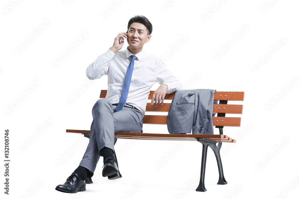 Confident young businessman talking on cell phone