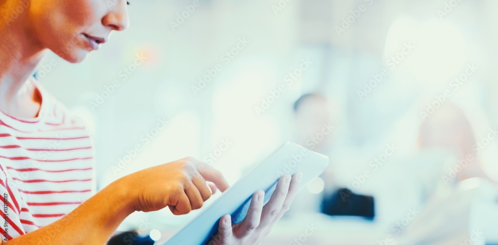 smiling young women using digital tablet 