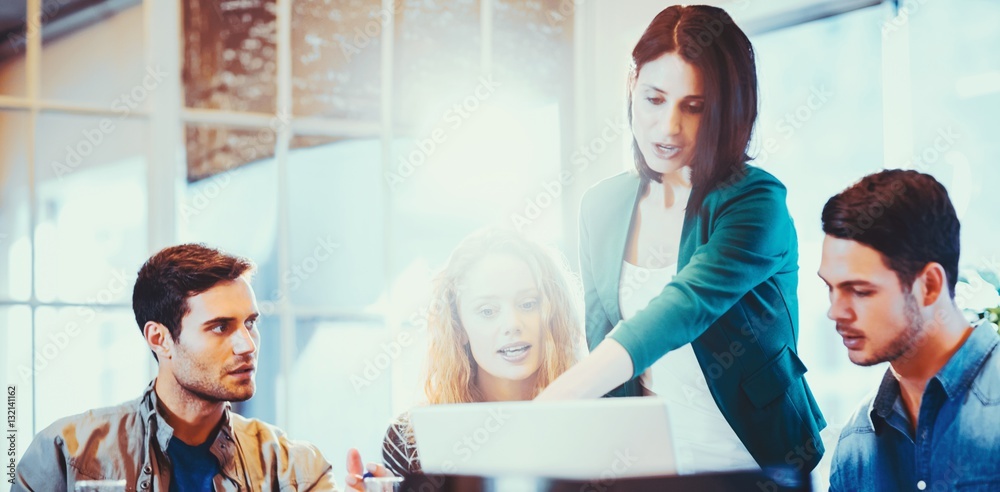 Group of young colleagues using laptop