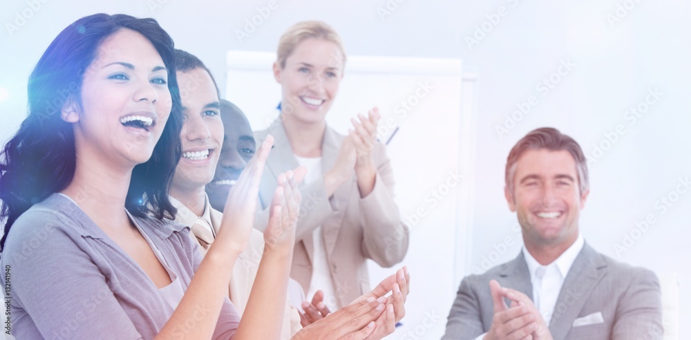 Cheerful business people applauding in a meeting