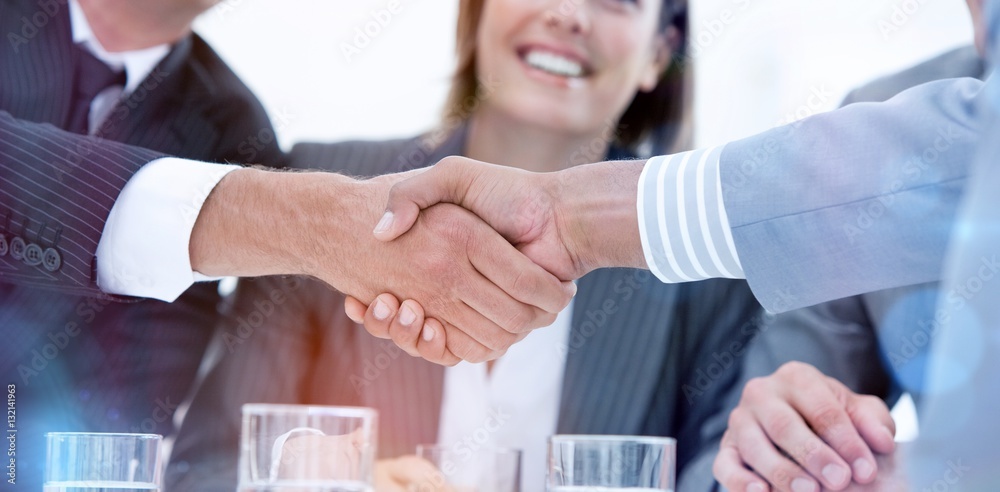 Smiling business people closing a deal