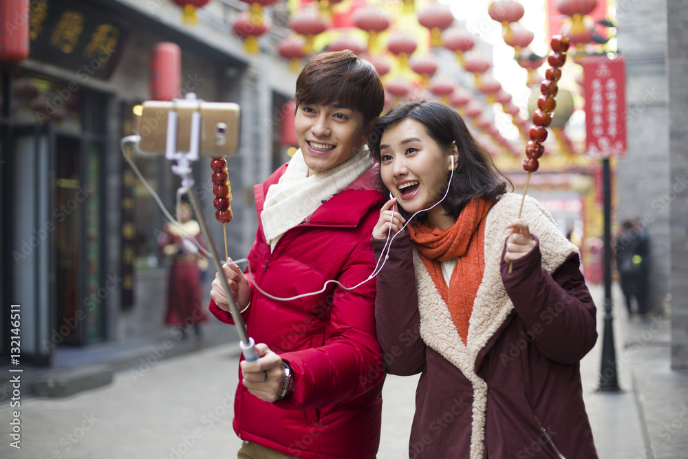 Young couple taking self portrait with a smart phone