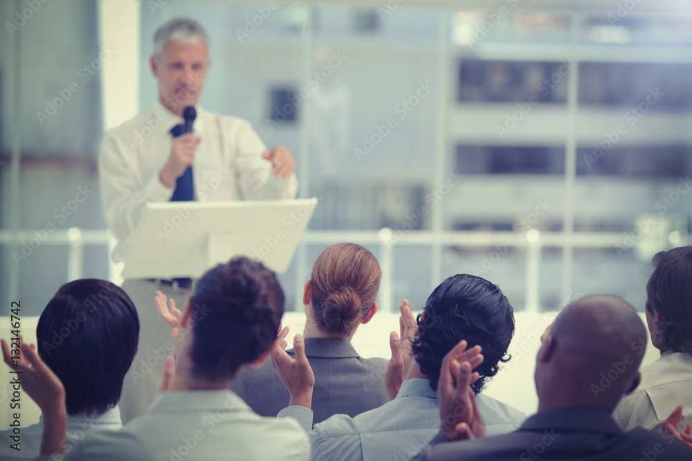 Business team applauding a mature businessman