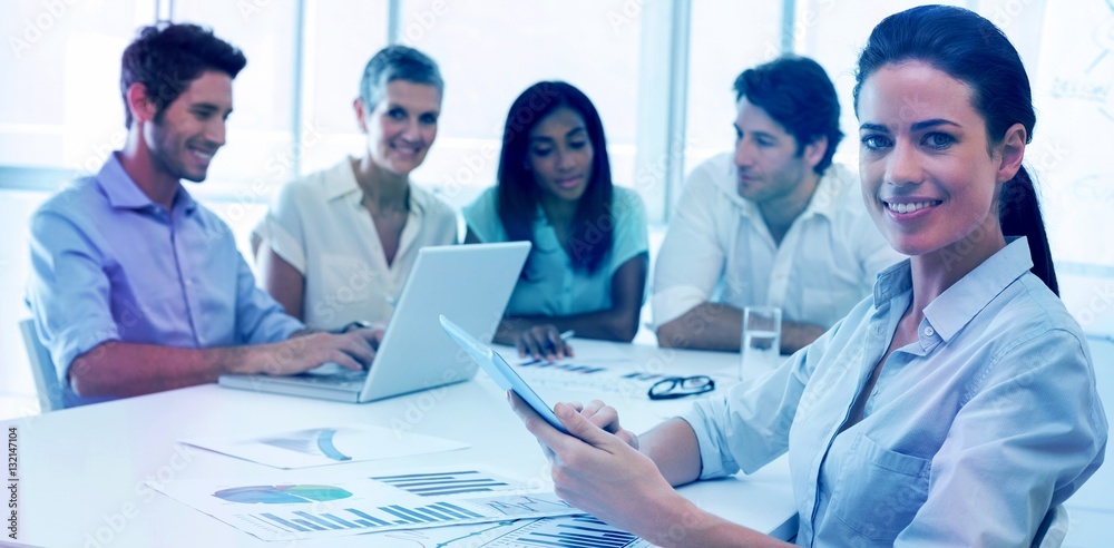 Attractive businesswoman smiling in business meeting